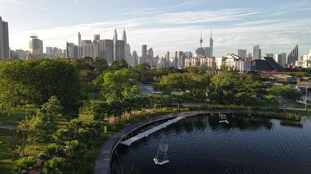 kuala lumpur park sunrise sun with blue lake and pedestrian jog