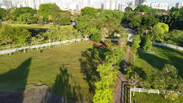 kuala lumpur park sunrise sun with blue lake and pedestrian jog
