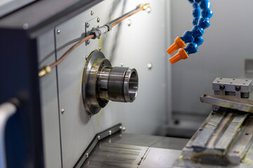 A close-up of a modern industrial machine with robotic arms and moving parts, showcasing precision manufacturing