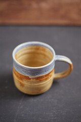 Ceramic cup on rustic background