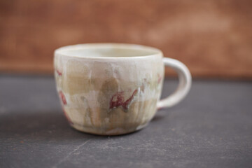 Ceramic cup on rustic background