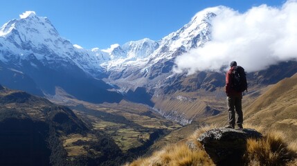 Fototapeta premium Majestic snow-capped peaks and a hiker enjoying breathtaking mountain views in a lush valley under a clear sky