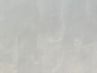 Naklejka premium Abstract Grunge Decorative Rough Uneven Stucco Wall Background Art texture.Raw And Weathered Concrete Texture In Soft Gray With Subtle Layered Patterns For A minimalist And Urban Aesthetic Texture.