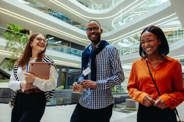 Cheerful colleagues walking together in a modern corporate setting