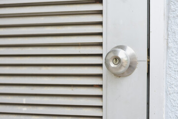This door design, with its horizontal slats and round metallic doorknob, combines simplicity and functionality.