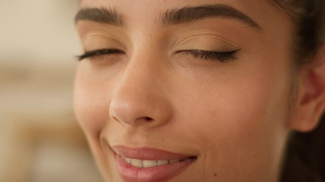 Extreme close up face Indian beautiful healthy woman Arabian satisfied carefree smiling businesswoman business girl medicine health beauty treatment skin care natural make-up looking at camera at home
