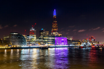 Obraz premium Night view of London South Bank skyline during the Chritmas season. Reflection in water.
