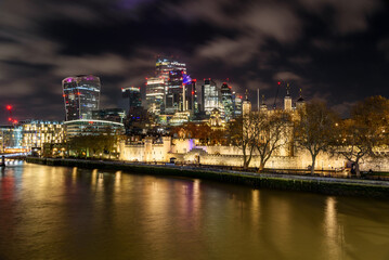 Fototapeta premium View of the Tower of London the City skyline at night in winter. Long exposure.