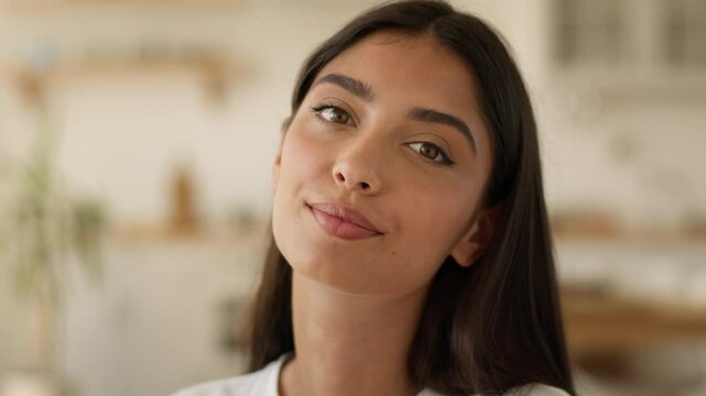 Portrait having fun fooling joyful happy smiling funny Arabian attractive ethnic woman lady headshot grimacing at home looking at camera Indian girl female showing tongue humorous grimace at apartment