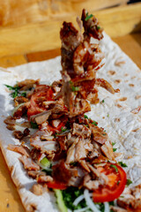 Making Shawarma: Cutting grilled meat