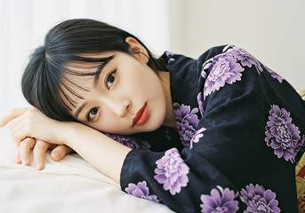 A woman lying down in a purple kimono- traditional attire