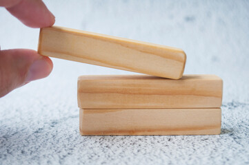 Hand holding wooden block with customizable space for text. Copy space concept