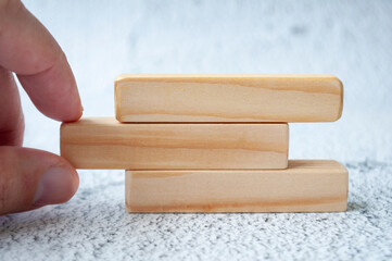 Hand pulling wooden block with customizable space for text. Copy space concept