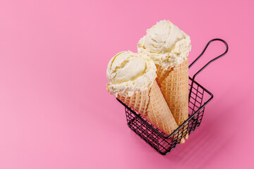 A refreshing ice cream cones set against a vibrant pink background