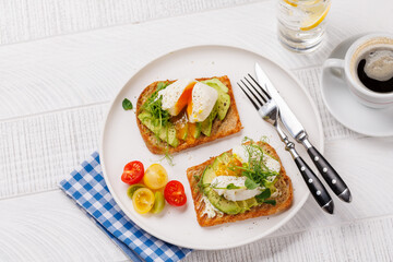 Delicious avocado toasts topped with perfectly cooked poached eggs