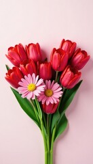 Fototapeta premium Red tulips and daisies forming a heart shape with stems and leaves, arrangement, valetine