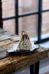 Beautiful and delicious cottage cheese Easter cake with walnuts and candles on a wooden background