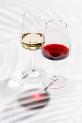 Two wine glasses filled with red and white wine