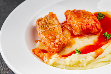Fish in tomato sauce and mashed potatoes tasty fresh delicious gourmet food background table rustic food top view copy space