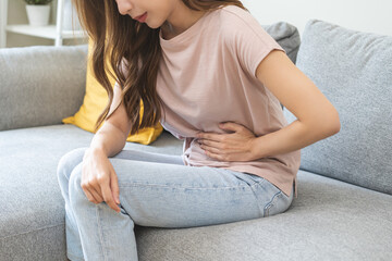 Flatulence asian young woman intolerance hand in stomach ache, suffer from food poisoning,...