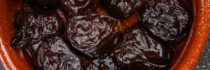 Dried prunes smoked drained plum gourmet food background on the table rustic food top view copy space keto and paleo diet vegetarian and vegan food