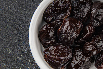 Dried prunes smoked drained plum gourmet food background on the table rustic food top view copy...