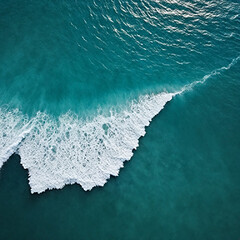 Aerial view beautiful of sea waves from drone. Stock image of blue color of ocean water, sea surface. Top view on turquoise waves, clear water surface texture.

