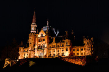 Fototapeta premium Photograph of a large, ornate castle at night.