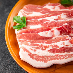 Bacon slices pork meat fresh gourmet food background on the table rustic food top view copy space