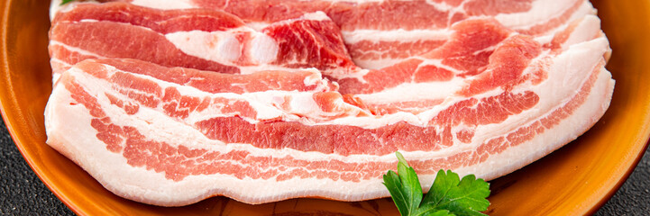 Bacon slices pork meat fresh gourmet food background on the table rustic food top view copy space