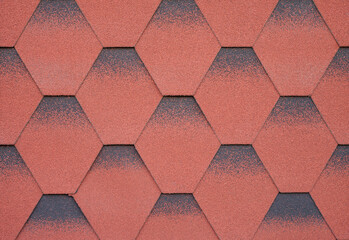 Texture of red hexagonal bitumen tiles background close up