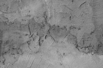 gray background, photo shows texture of plaster on concrete wall close-up