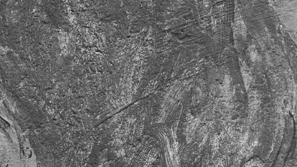 gray background, photo shows texture of building wall with lines and strokes of paint and plaster