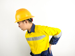 asian engineer wearing yellow helmet feeling back pain on white background