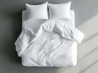 Obraz premium Freshly made white bed with rumpled sheets in bright sunlight