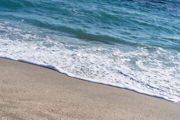Close up of beautiful and clear ocean waves on the beach