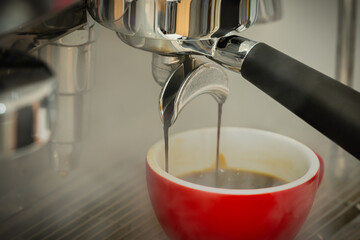 Red cup of americano coffee on black background for breakfast.Top view hot black coffee in restaurant make by barista on best of menu in the coffee shop.Refresh menu.