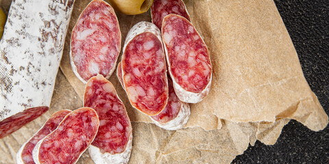 Fuet sausage Spanish meat delicacy fresh gourmet food background on the table rustic food top view copy space