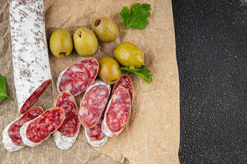 Fuet sausage Spanish meat delicacy fresh gourmet food background on the table rustic food top view copy space