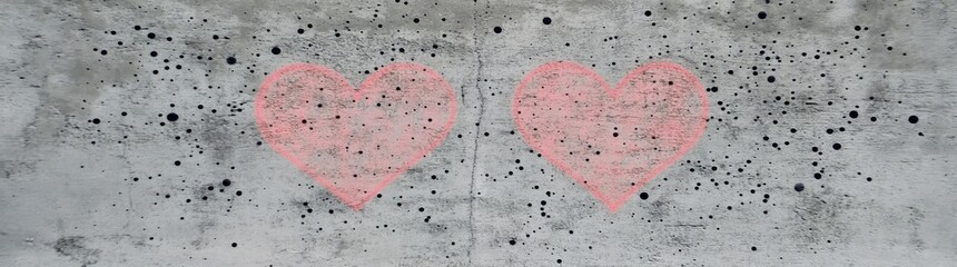 Long banner with a pink heart on rustic grey concrete wall texture background