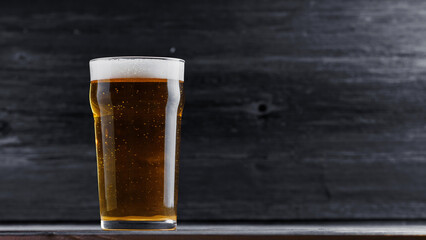 Beer glass on wooden black table