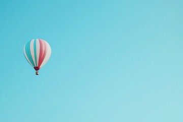 Naklejka premium colorful hot air balloon floats serenely against clear blue sky with expansive copy space above capturing tranquility