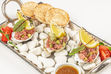 Raw Tuna tartar with avocado and sauce, Food recipe background. Close up. top view