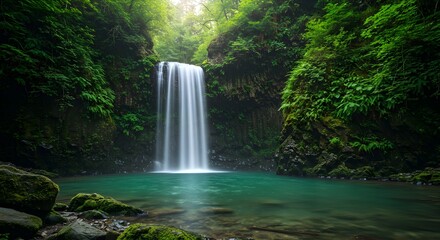 Majestic Waterfall Cascading into Emerald Pool Surrounded by Lush Greenery
