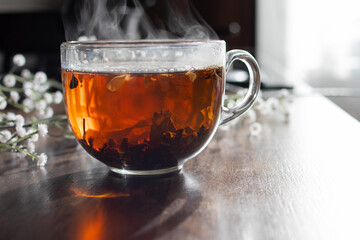 Freshly brewed tea in a transparent glass cup