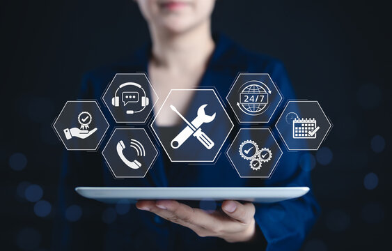 Technical support and customer service concept. Business professional holding tablet with icons representing customer support, troubleshooting, 24/7 service, quality assurance, and communication.