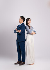 Full body image of young asian business couple posing on white background