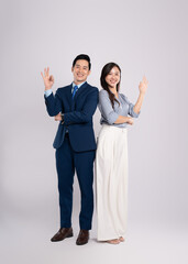 Full body image of young asian business couple posing on white background