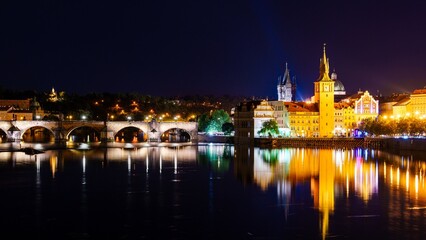 A breathtaking panoramic night view of Prague, featuring the illuminated Prague Castle, the historic Charles Bridge, and the serene Vltava River, creating a magical atmosphere in Prague.