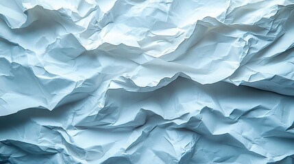 Obraz premium Crumpled white paper provides a textured abstract background for design and art, conveying imperfection or creative chaos.